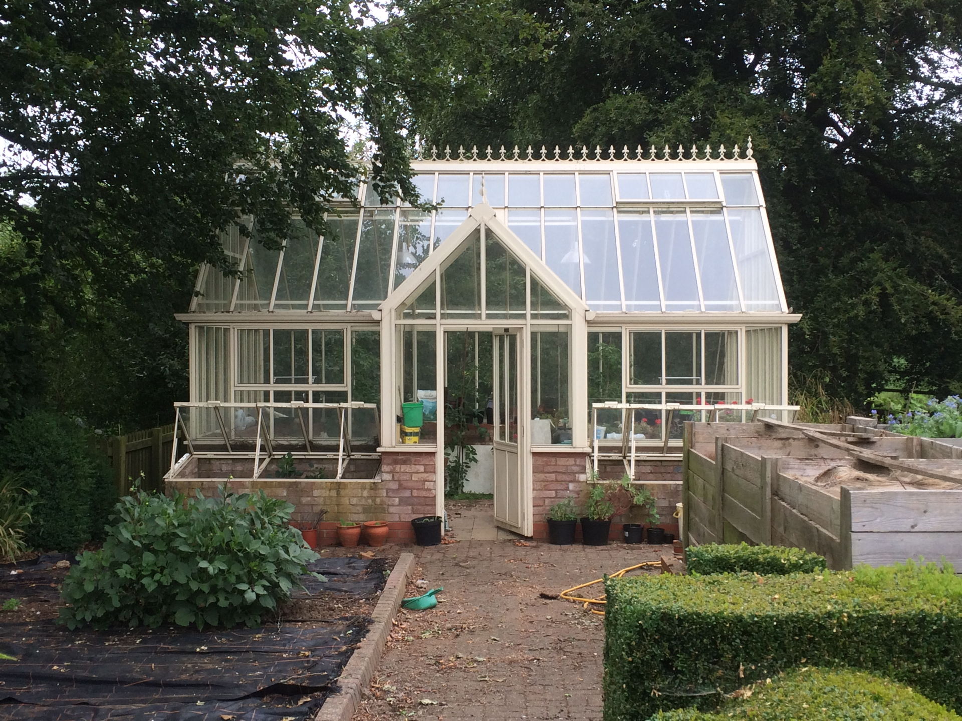 Garden specialists in Cardiff Florek Renovation mature garden with glass house
